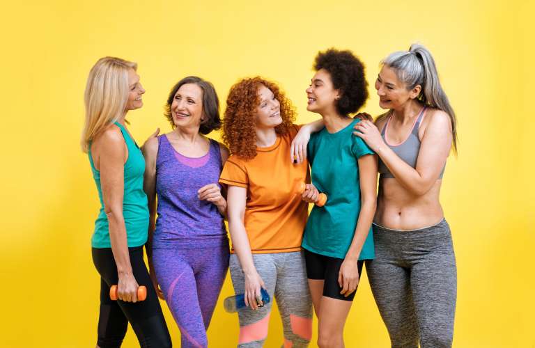 Group of women with different body, age, and ethnicity making sport. Female models wearing sport outfits having fun at the gym. Concept about body positivity, self acceptance and lifestyle